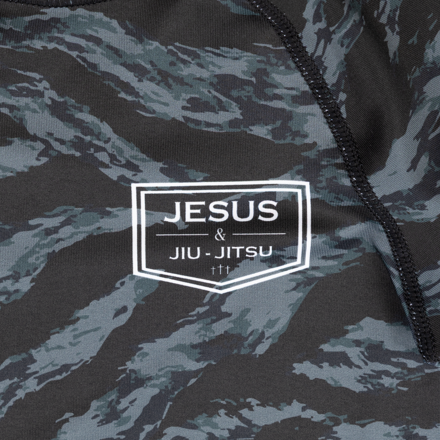 closeup of JJJ logo on youth camo rashguard