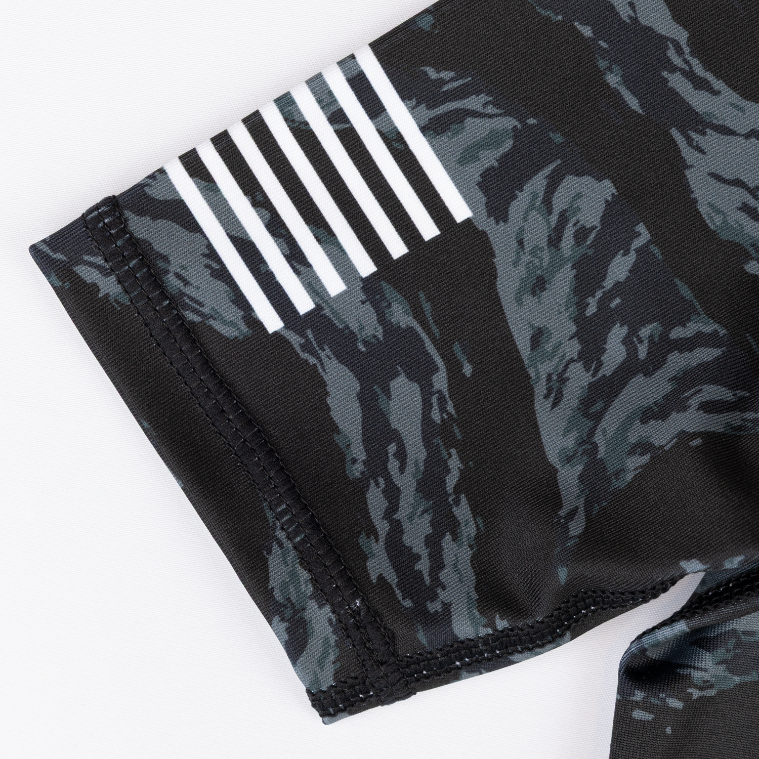 Flag graphic on sleeve of youth camo rashguard