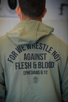 Rear view of man wearing pine hoodie with text "FOR WE WRESTLE NOT AGAINST FLESH & BLOOD EPHESIANS 6:12"