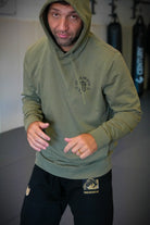 Man in pine hoodie with JJJ logo on left chest