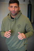 Man in pine hoodie with JJJ logo on left chest