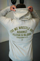 Rear view of man wearing smoke hoodie with text "FOR WE WRESTLE NOT AGAINST FLESH & BLOOD EPHESIANS 6:12"