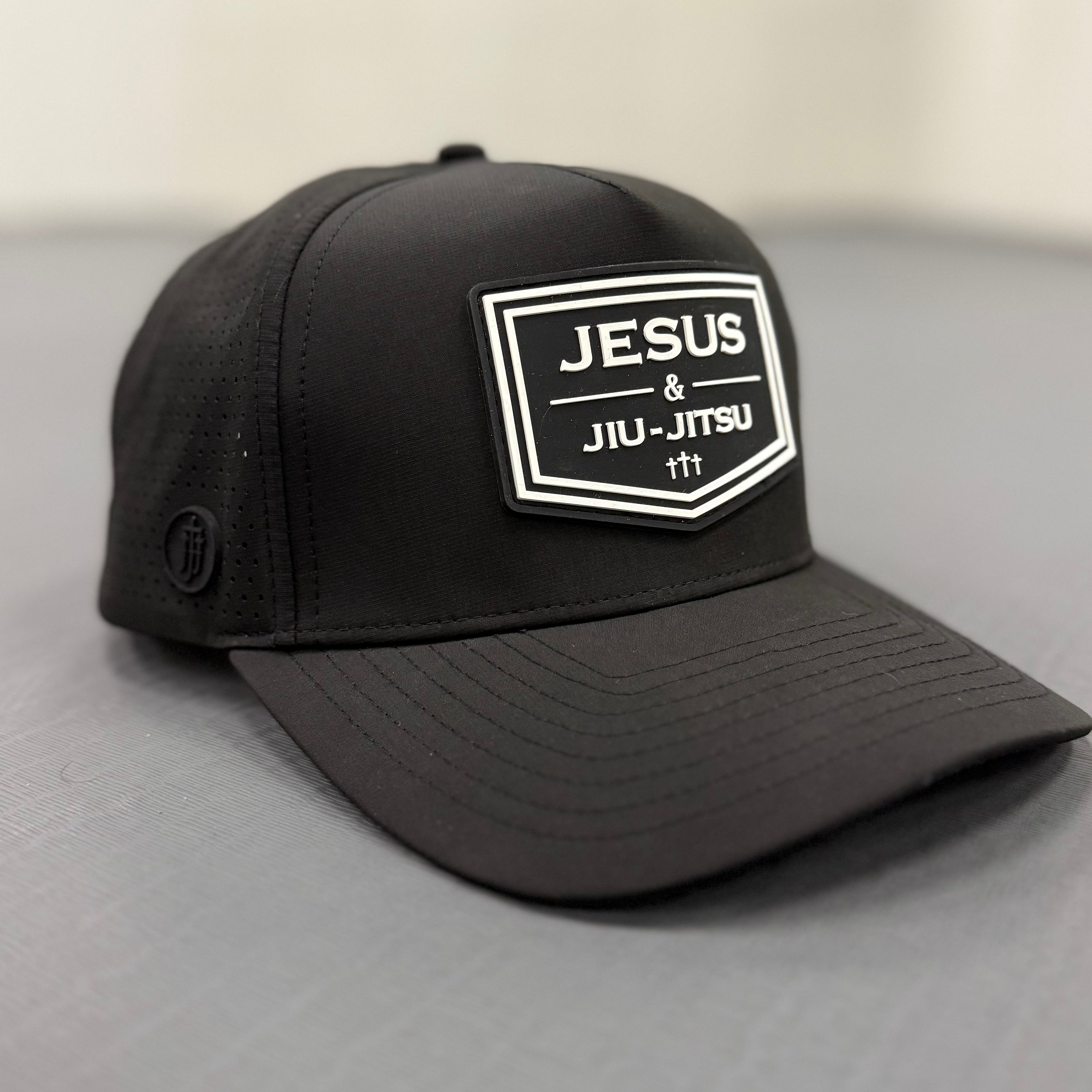 Black cap with 'Jesus & Jiu-Jitsu' logo on a light gray background