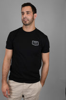 Man wearing shirt with JJJ logo on left chest