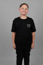 child wearing black tee with JJJ logo on left chest