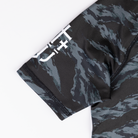 JJJ logo on sleeve of youth camo rashguard