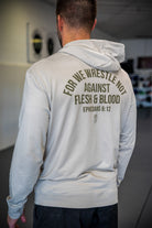 Rear view of man wearing smoke hoodie with text "FOR WE WRESTLE NOT AGAINST FLESH & BLOOD EPHESIANS 6:12"