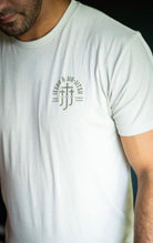 Man in sand tee with JJJ logo on left chest